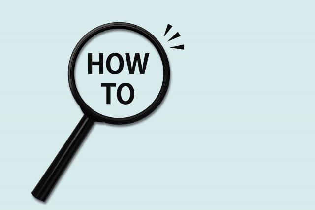 虫眼鏡の真ん中にHOW TOと書かれている画像
